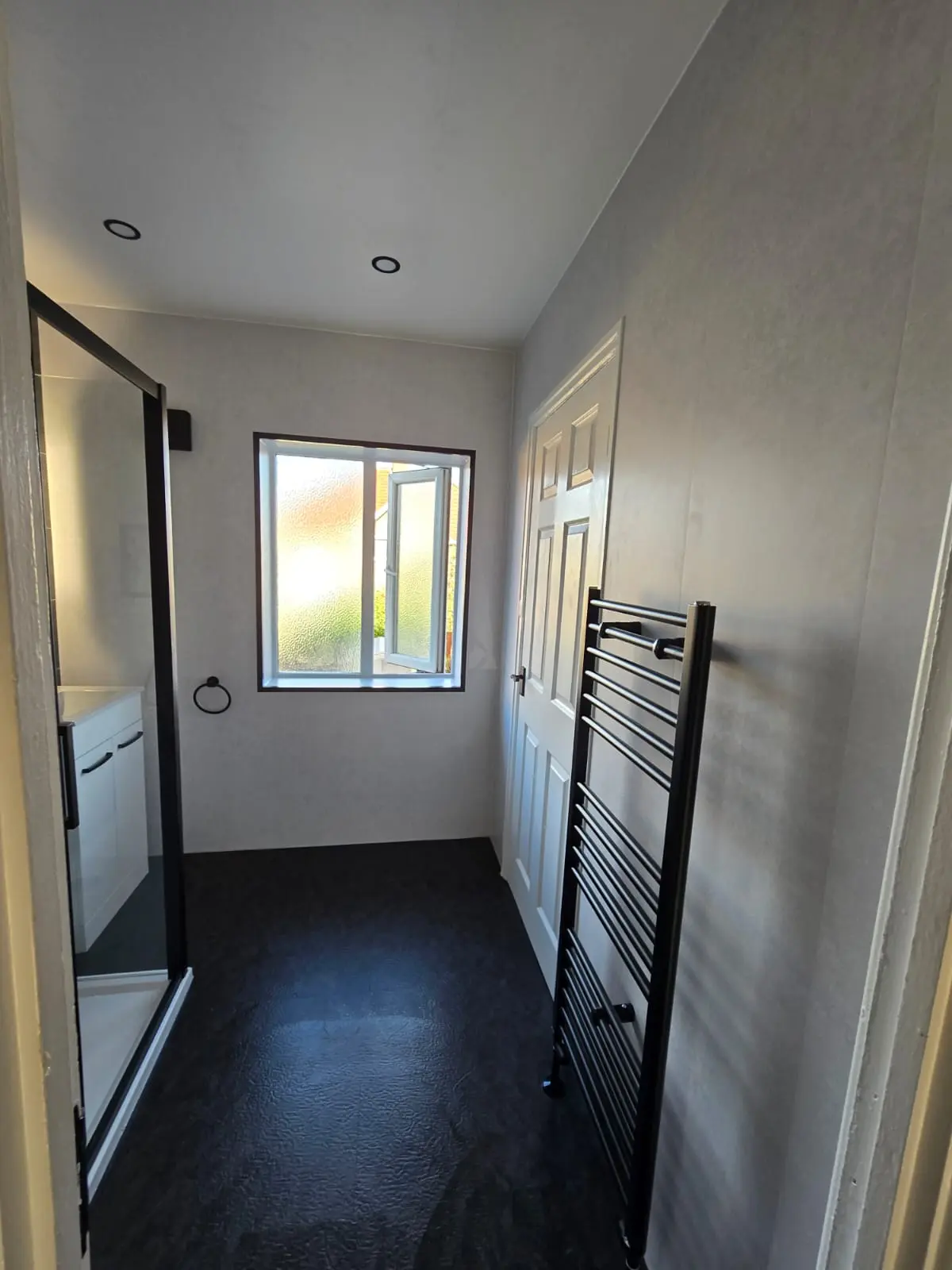 Sunderland bathroom from the doorway — black shower cubicle, spotlights and black heated towel rail